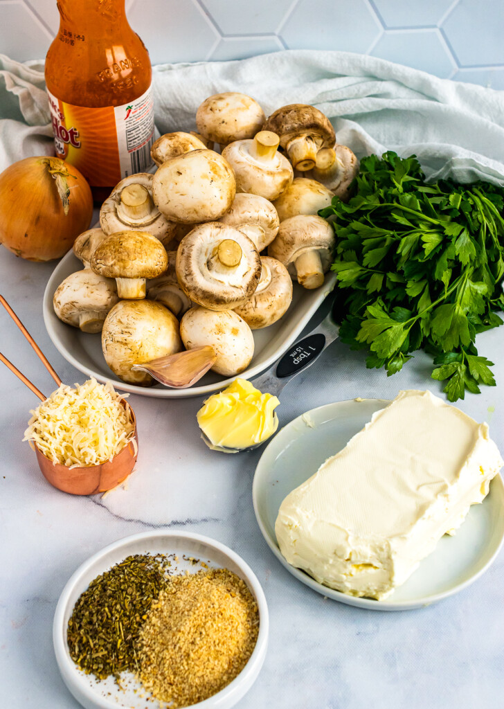 Mushrooms, cream cheese, seasoning and herbs for Stuffed Party Mushrooms.