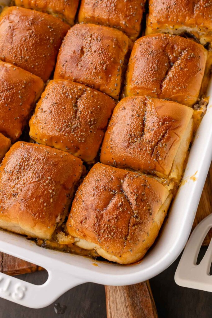 Pan of baked Beef Sliders with a buttery poppy seed topping.