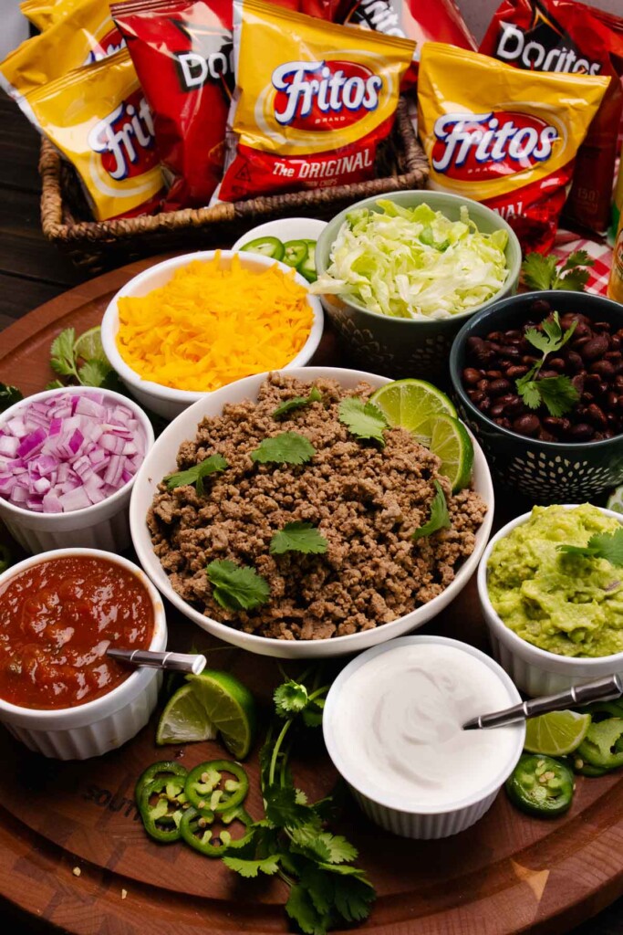 Walking Taco's board with all the toppings and taco meat.