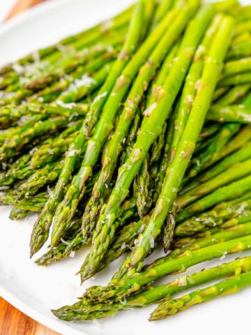 Beautiful, perfectly roasted asparagus seasoned with salt, and pepper then topped with Parmesan cheees makes the perfect side dish any time of the year.