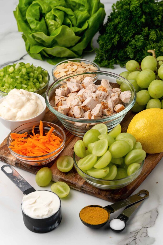 Chicken, grapes, celery, carrots, almonds and ingredients for dressing for Party Chicken Salad.