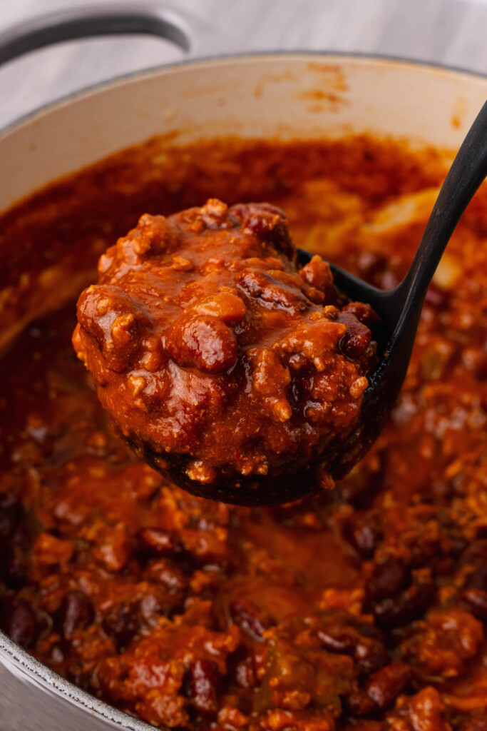 Easy recipe for Beef Chili made with beans, bacon and peppers is a great dish for any party or family meal served with cheese, corn chips and sour cream.