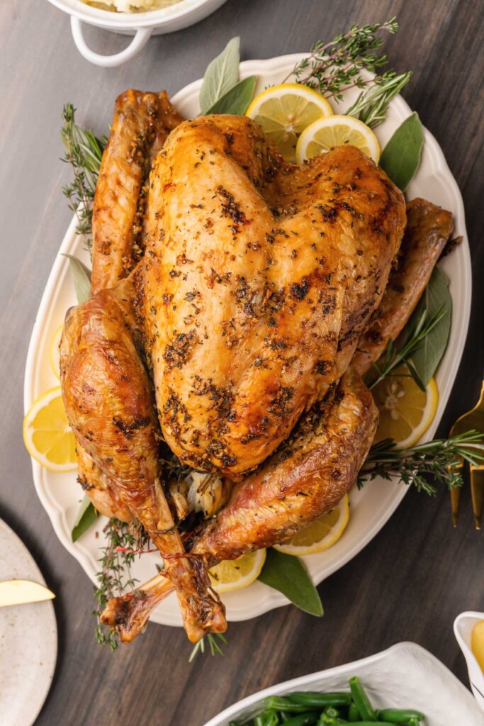 Juicy, perfect Roasted Turkey with sage, thyme, lemons and garlic is perfect for serve for the holidays or any time you need a beautiful, delicious main dish.