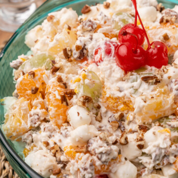 Holiday Ambrosia Salad is festive fresh and easy to make with cherries, oranges, grapes, pecans and marshmallows for a treat that can be served as a salad or dessert.